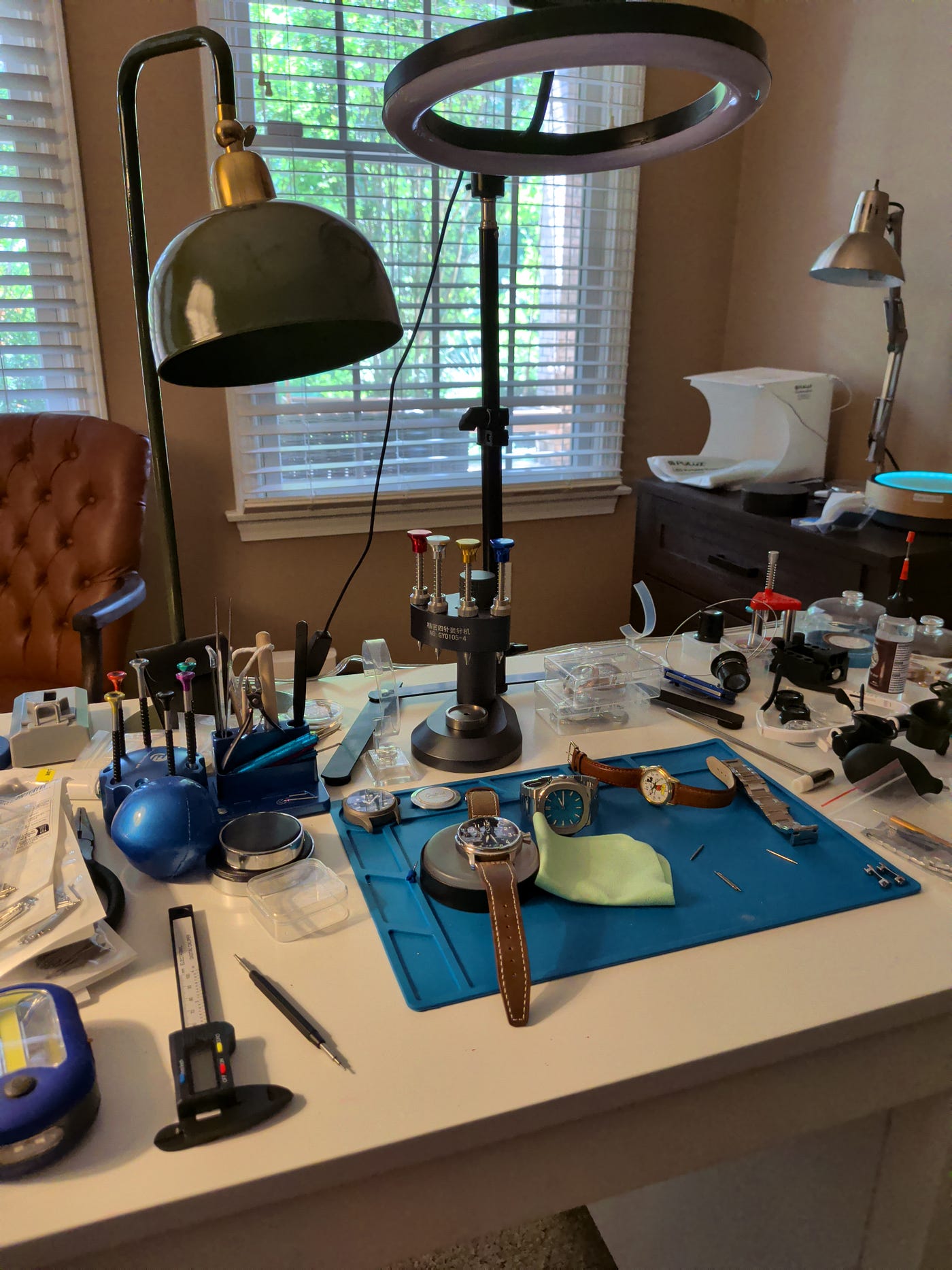 An assortment of Griffith Watch Company timepieces arranged on a workbench
